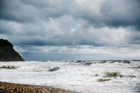Storm clouds over the sea. Dramatic sky and giant waves.の写真素材