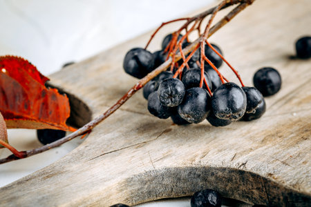 Chokeberry (Aronia melanocarpic) on a wooden tableの写真素材