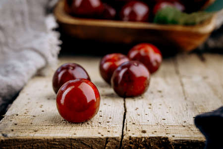 Ripe red cherries on a wooden table.の写真素材