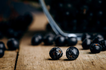 Chokeberry (Aronia melanocarpic) on a wooden tableの写真素材