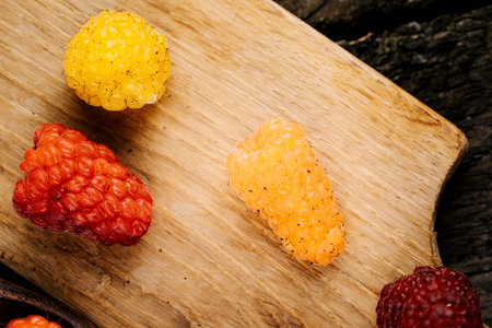Fresh juicy raspberries in a wooden table. Summer still life with raspberries. A place to copy.の写真素材