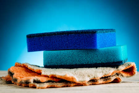 sponge for washing dishes on a blue backgroundの写真素材