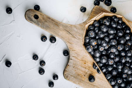 Chokeberry (Aronia melanocarpic) on a wooden tableの写真素材