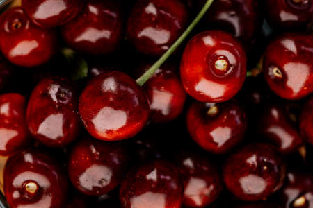 Ripe cherry with stems and leaves. A large collection of fresh red cherries. Ripe cherry background.の写真素材
