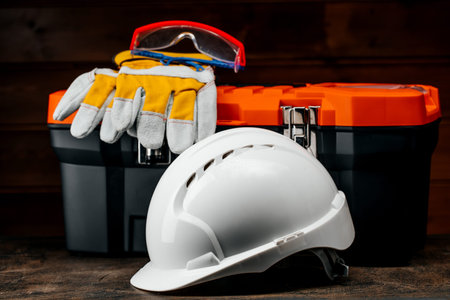 Plastic box with a set of tools with a construction protective helmet
