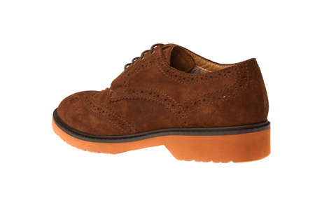 western brown leather shoe with laces with orange sole isolated on white backgroundの写真素材