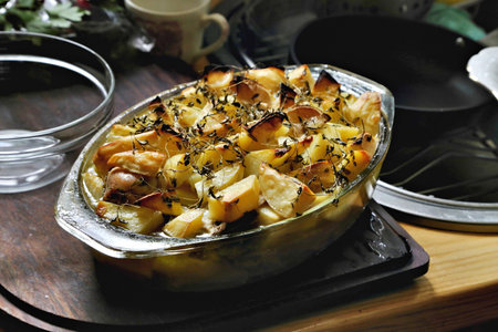Cottage pie with potatoes and meat, presented on wooden board.の写真素材