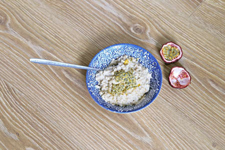 Healthy brown rice pudding, dessert with fruits on topの写真素材