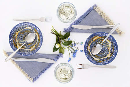 Empty plates after soup. Romantic dinner for two with white wine. Homey atmosphere clean white table. Top viewの写真素材