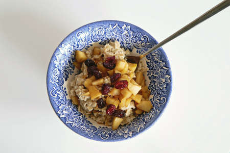 Healthy brown rice pudding, dessert with fruits on topの写真素材