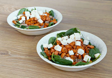 Healthy lunch with feta and spinach on wooden backgroundの写真素材