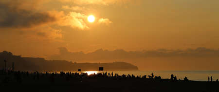 Sunset on the crowded beachの写真素材