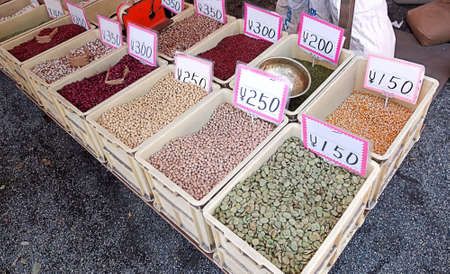 Different kinds of beans and chickbeans in boxes on japanese stallの写真素材