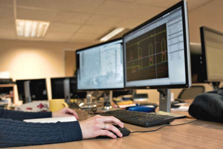 Woman's hand holding a mouse for office design work. Female architect designing buildingの写真素材