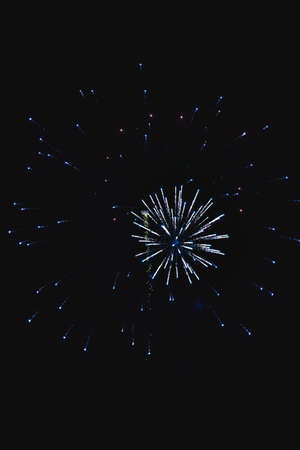 Shiny natural fireworks on dark black sky background with a little smokeの写真素材