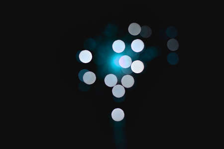 Light blur and defocus bokeh circles on black sky backgroundの写真素材