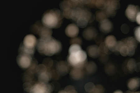 Light blur and defocus bokeh circles on black sky backgroundの写真素材