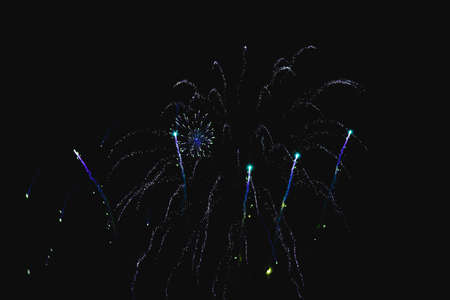 Shiny natural fireworks on dark sky background with little smokeの写真素材