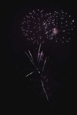 Shiny natural fireworks on dark sky background with little smokeの写真素材