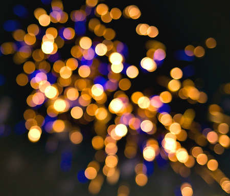 Light blur and defocus bokeh circles on black sky backgroundの写真素材