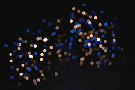 Light blur and defocus bokeh circles on black sky backgroundの写真素材