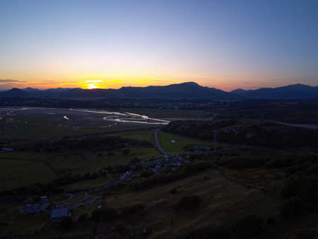 Aerial view, Drone panorama colorful sunset over hills, sea, Snowdonia mountains in background in North Walesの写真素材
