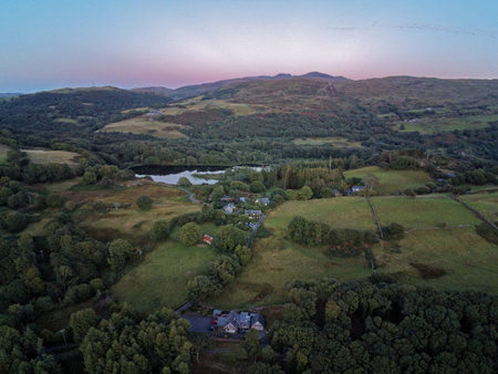 Aerial view, Drone panorama golden hour sunset over hills, Snowdonia mountains in background in...