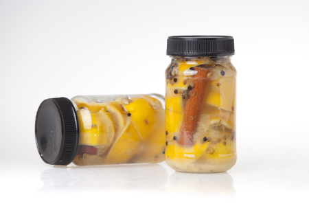 Preserved lemons in jars with cinnamon and coriander seedsの写真素材