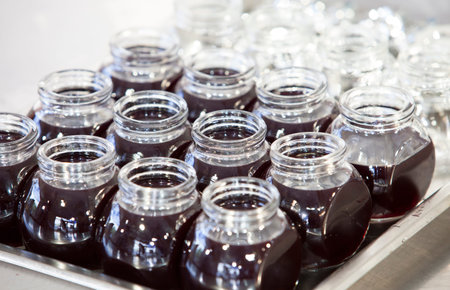 Cooked mulberry jam in glass jars ready for storage