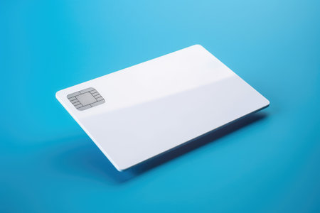 Blank white credit card with microchip on blue, copy space, created using generative ai technology. Emv chip, banking, spending, technology and finance mock up concept digitally generated image.の素材