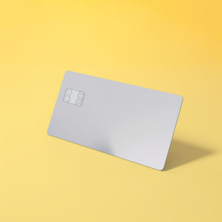 Blank grey credit card with microchip on yellow, copy space, created using generative ai technology. Emv chip, banking, spending, technology and finance mock up concept digitally generated image.の素材