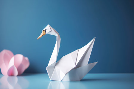 Close up of origami figure of swan on blue background, created using generative ai technology. Origami, art and japanese tradition concept digitally generated image.の素材