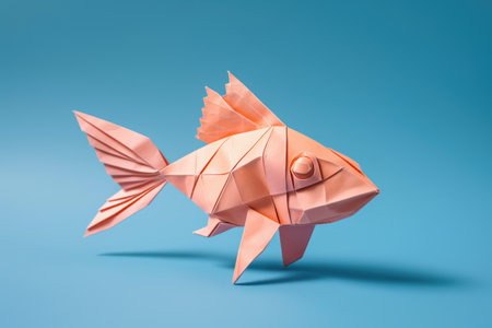 Close up of origami figure of fish on blue background, created using generative ai technology. Origami, art and japanese tradition concept digitally generated image.の素材