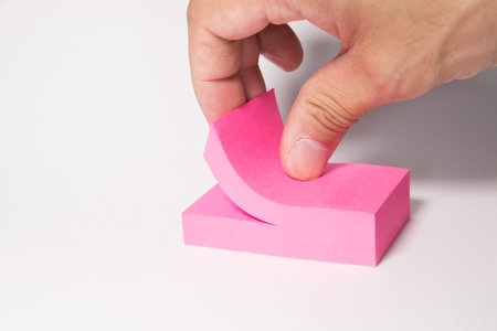 Hand pulling notepaper sticker