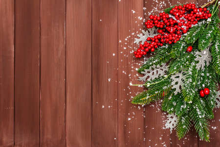 Christmas background. New Year fir tree, dog rose, fresh leaves and artificial snow. Wooden boards backdrop, copy space, top viewの写真素材