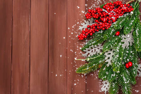 Christmas background. New Year fir tree, dog rose, fresh leaves and artificial snow. Wooden boards backdrop, copy space, top viewの写真素材