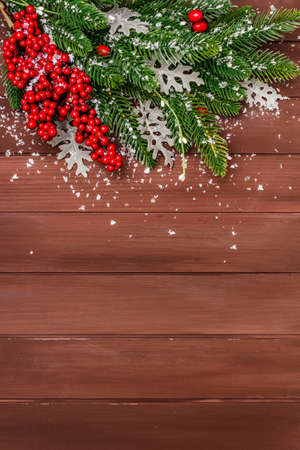 Christmas background. New Year fir tree, dog rose, fresh leaves and artificial snow. Wooden boards backdrop, copy space, top viewの写真素材