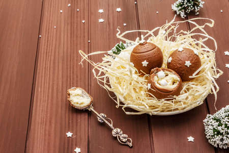 Homemade chocolate candies with star sprinkles. Festive sweet dessert, Christmas (New Year) spirit. Wooden boards background, copy spaceの写真素材