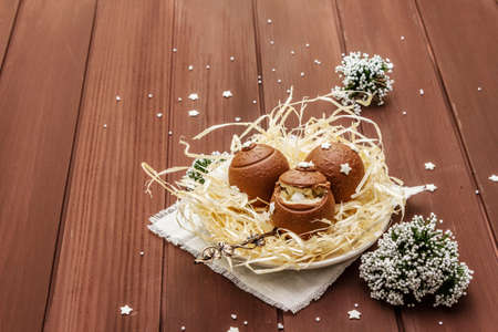Homemade chocolate candies with star sprinkles. Festive sweet dessert, Christmas (New Year) spirit. Wooden boards background, copy spaceの写真素材
