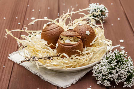 Homemade chocolate candies with star sprinkles. Festive sweet dessert, Christmas (New Year) spirit. Wooden boards background, close upの写真素材