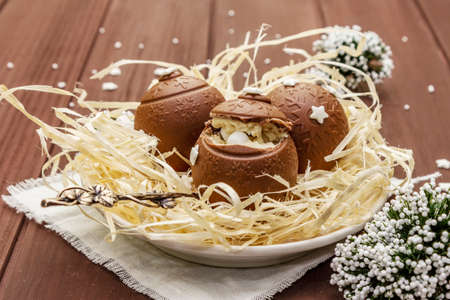 Homemade chocolate candies with star sprinkles. Festive sweet dessert, Christmas (New Year) spirit. Wooden boards background, close upの写真素材