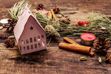 Spirit Christmas background. New Year tree, light house, dog rose, candles, spices, deer, cones. Nature decorations, vintage wooden boards, close upの写真素材