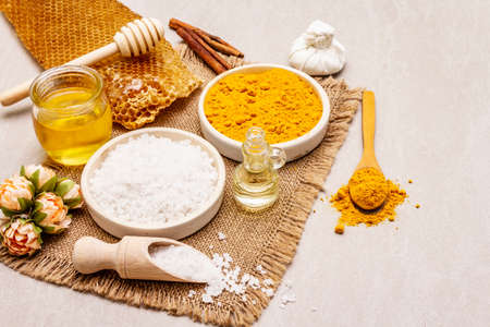 Personal care with natural ingredients. Healthy spa concept. Turmeric, sea salt, honey, cinnamon, oil. Stone concrete background, close upの写真素材