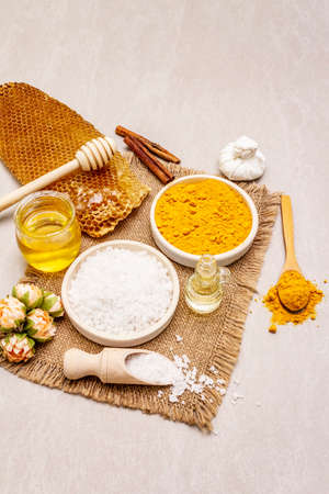 Personal care with natural ingredients. Healthy spa concept. Turmeric, sea salt, honey, cinnamon, oil. Stone concrete background, copy spaceの写真素材