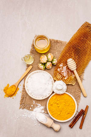 Personal care with natural ingredients. Healthy spa concept. Turmeric, sea salt, honey, cinnamon, oil. Stone concrete background, copy space, top viewの写真素材