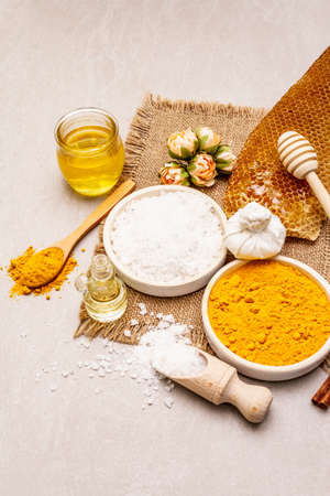 Personal care with natural ingredients. Healthy spa concept. Turmeric, sea salt, honey, cinnamon, oil. Stone concrete background, copy spaceの写真素材