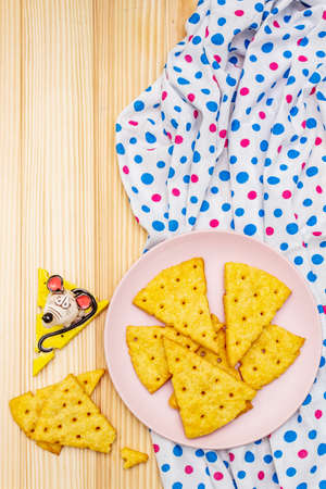 Funny kids cookies. Festive cheese crackers, New Year snack concept. Food, mouse sculpture, napkin. Wooden planks background, copy space, top viewの写真素材