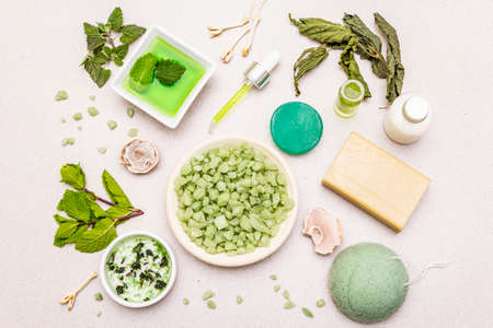 Healthy self-care. Minimalistic organic lifestyle. Comfort and natural pharmacy. Sea salt, herbal oil, dry and fresh leaves. Bowls, stone concrete background, top view, close upの写真素材
