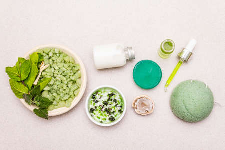 Healthy self-care. Minimalistic organic lifestyle. Comfort and natural pharmacy. Sea salt, herbal oil, dry and fresh leaves. Bowls, stone concrete background, copy space, top view, close upの写真素材
