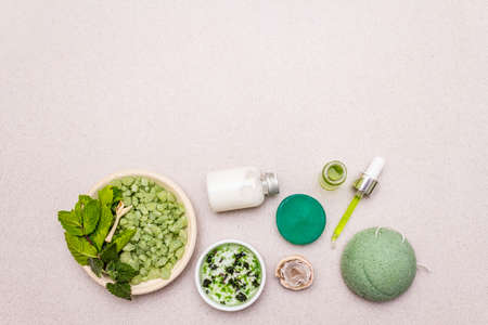 Healthy self-care. Minimalistic organic lifestyle. Comfort and natural pharmacy. Sea salt, herbal oil, dry and fresh leaves. Bowls, stone concrete background, copy space, top viewの写真素材